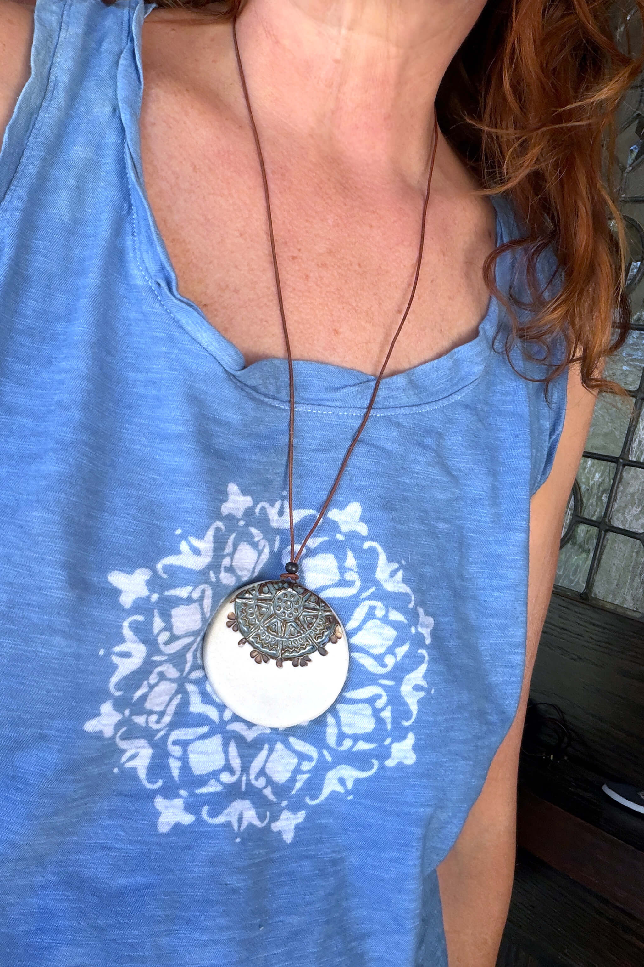 Handmade aqua and white porcelain mandala ceramic pendant necklace worn at long boho length on brown leather — tile inspired ceramic jewelry From the Fire FTF_0726 by Jester Swin