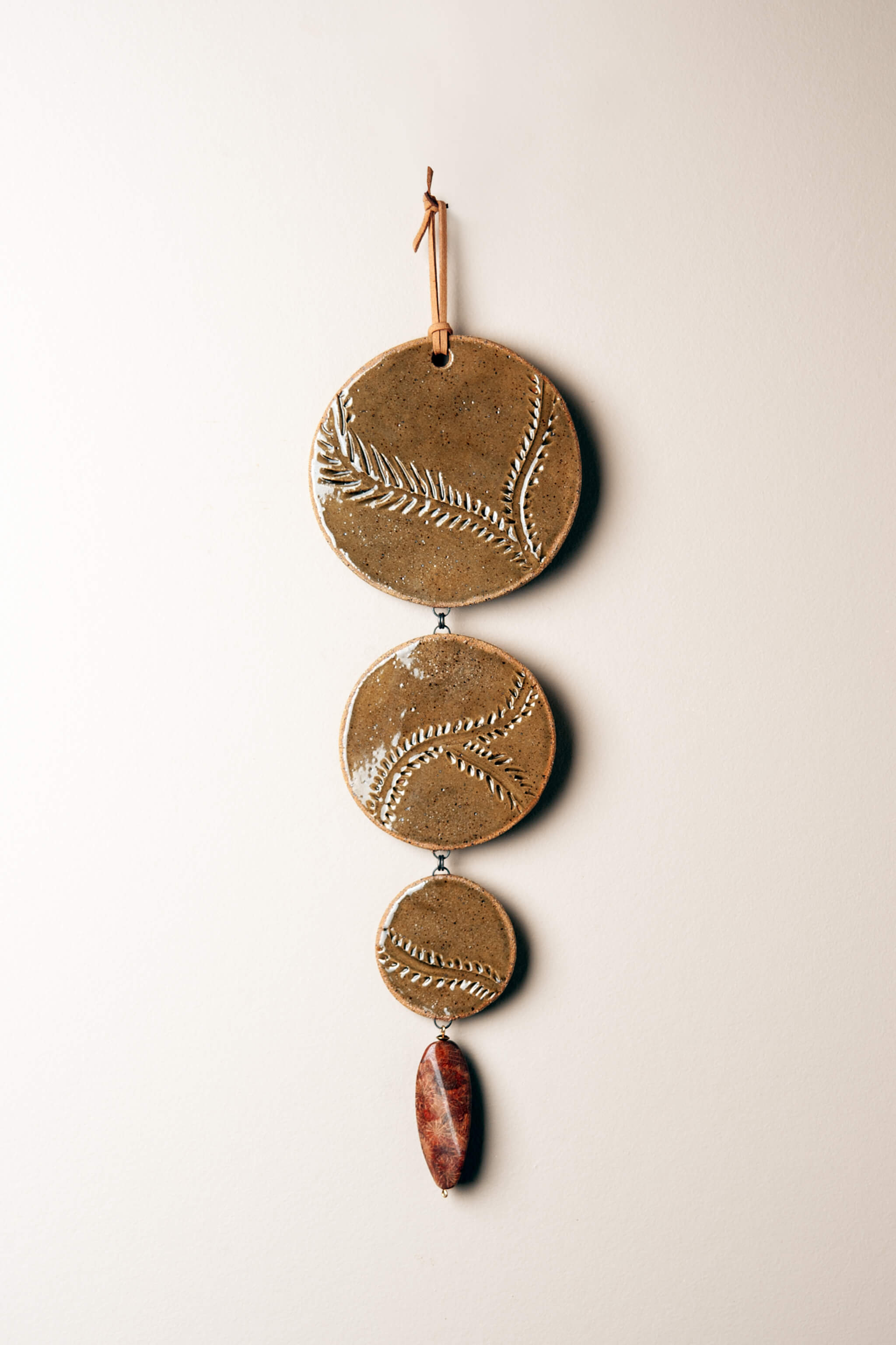 Medium handmade cascading ceramic wall hanging in olive green glaze with vine pattern and fossil coral agate drop, kiln fired by Jester Swink Santa Cruz Mountains — From the Fire FTF_0726