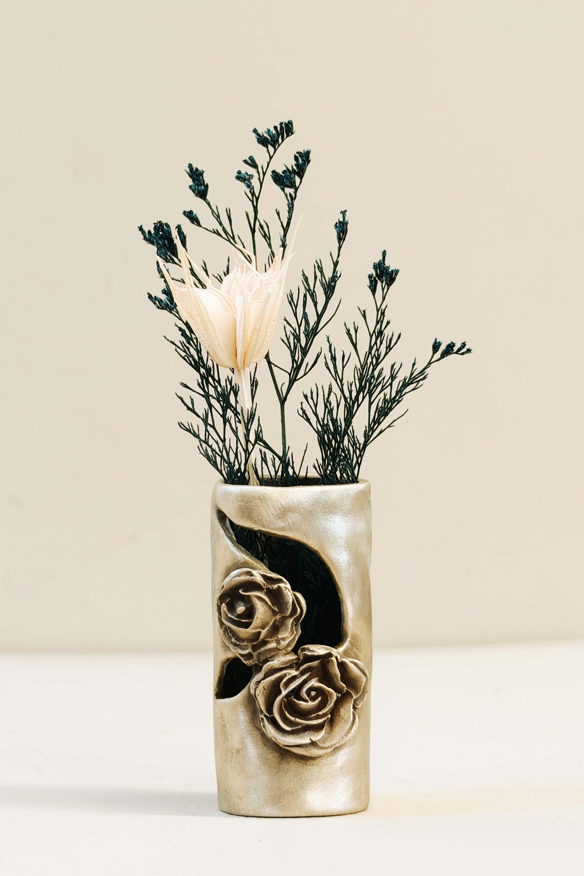 Handmade bronze mini bud vase with two roses in relief and a natural patina, styled with dried flowers, by Jester Swink Santa Cruz Mountains — From the Fire FTF_1026