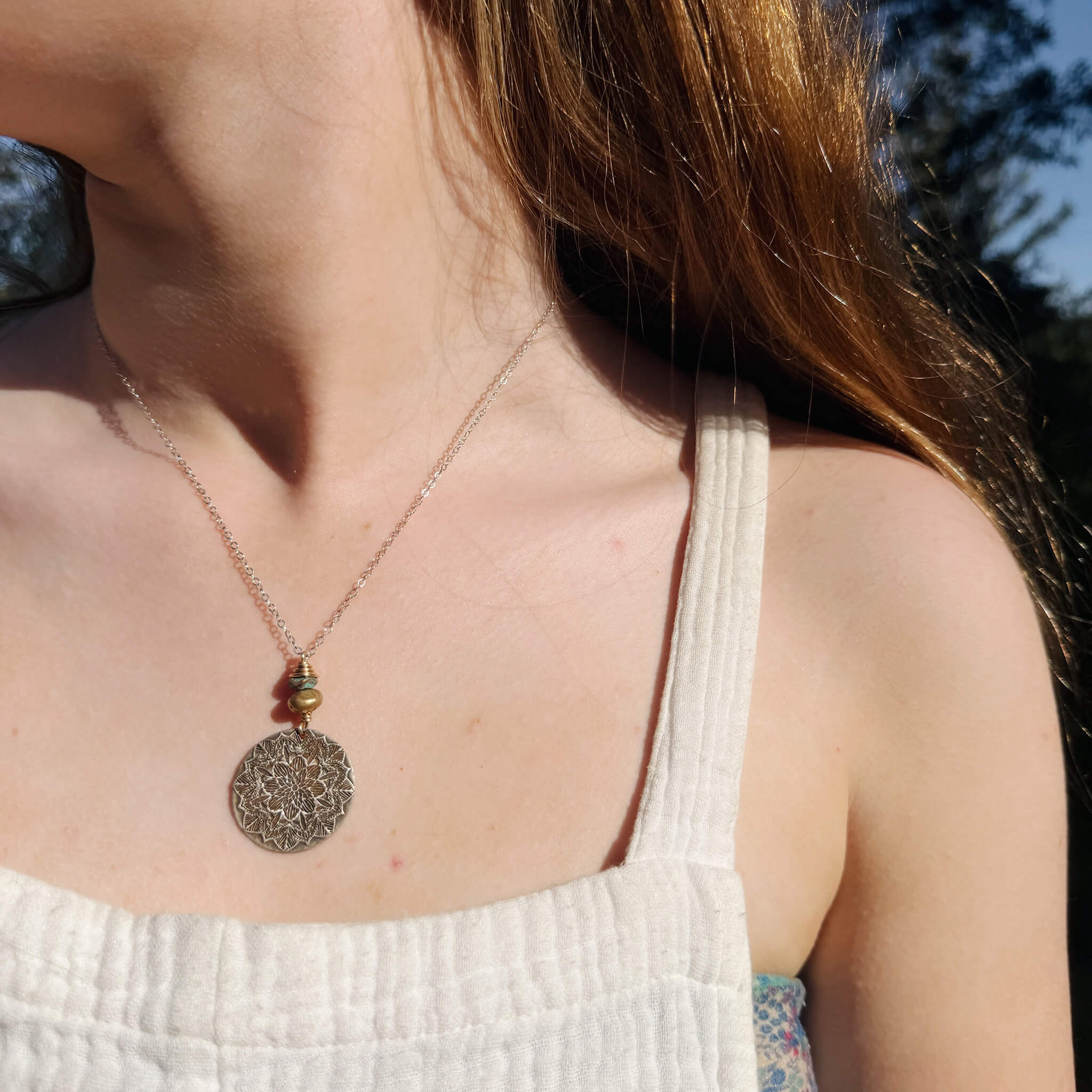 Handcrafted sterling silver mandala necklace lifestyle shot — nature inspired mixed metal mandala jewelry by Jester Swink, Santa Cruz Mountains