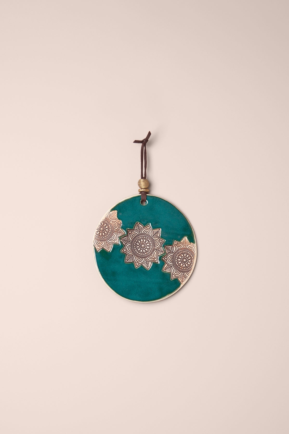 Small handmade circle ceramic wall hanging in Emerald glaze with three pressed mandalas and a brass bead, kiln fired by Jester Swink Santa Cruz Mountains — From the Fire FTF_1026