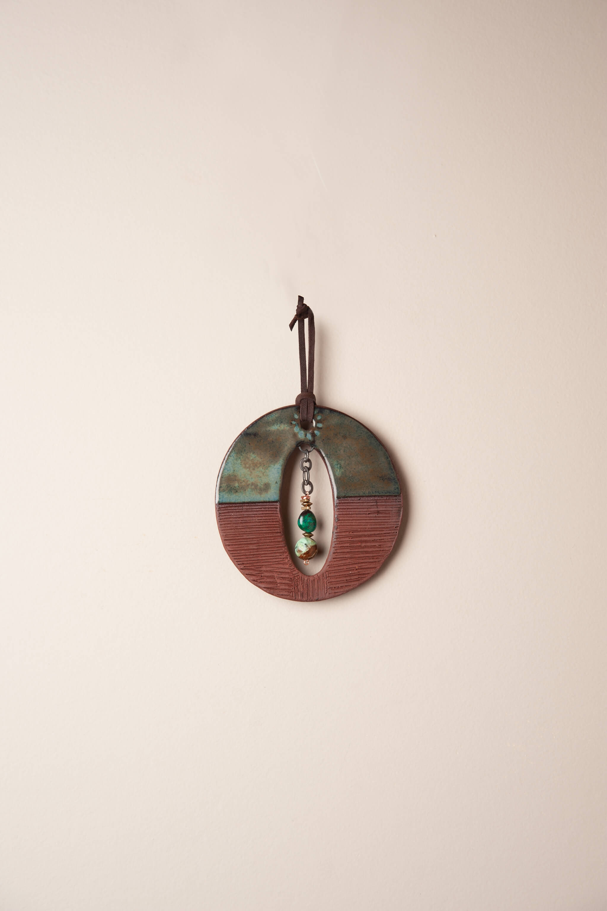 Small handmade ceramic circle wall hanging in forest green and terracotta with chrysocolla and chrysoprase on chain, kiln fired by Jester Swink Santa Cruz Mountains — From the Fire FTF_0726