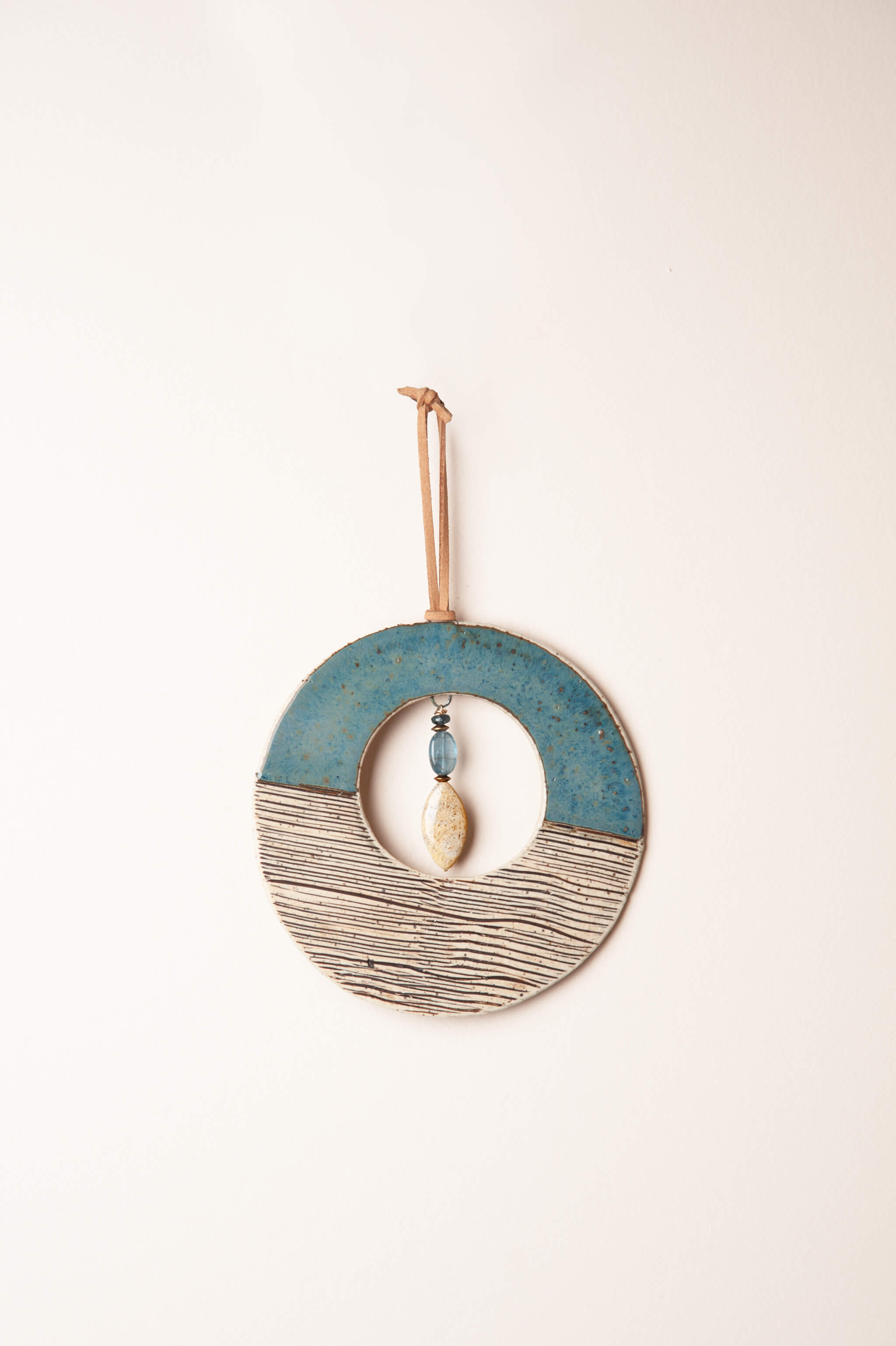Small handmade ceramic circle wall hanging in sea break blue with wave stripe pattern and kyanite, kiln fired by Jester Swink Santa Cruz Mountains — From the Fire FTF_0726