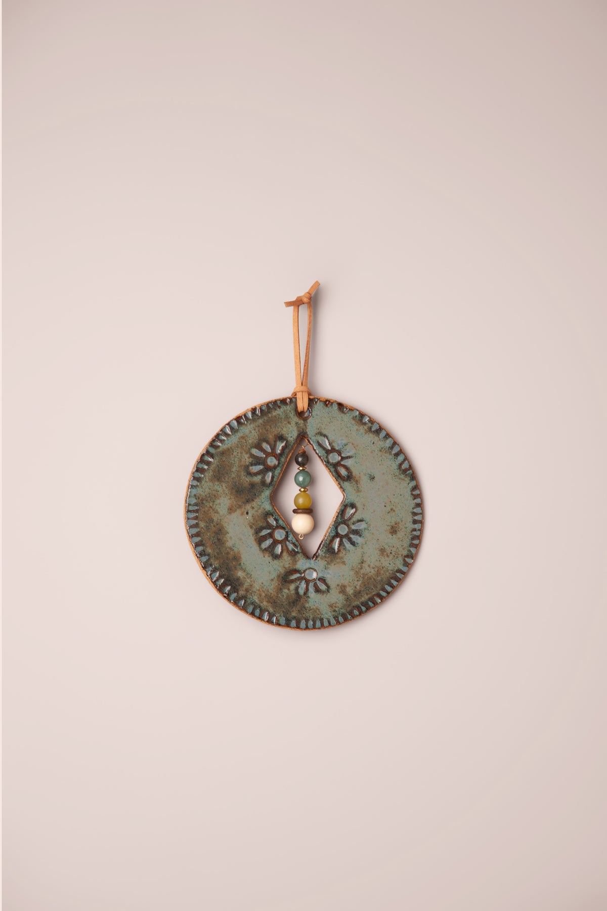Small handmade circle ceramic wall hanging in Sea Breeze glaze with pressed flowers and rays and a four stone dangle, kiln fired by Jester Swink Santa Cruz Mountains — From the Fire FTF_1026