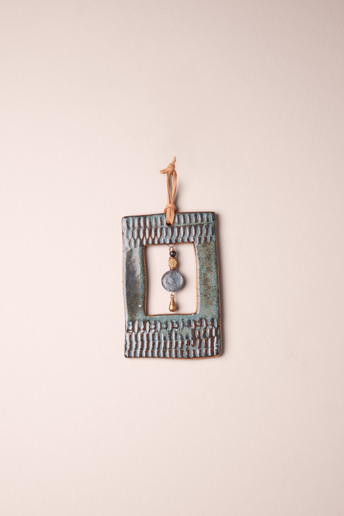 Small handmade rectangle ceramic wall hanging in Sea Breeze glaze with a kyanite and brass dangle, kiln fired by Jester Swink Santa Cruz Mountains — From the Fire FTF_1026