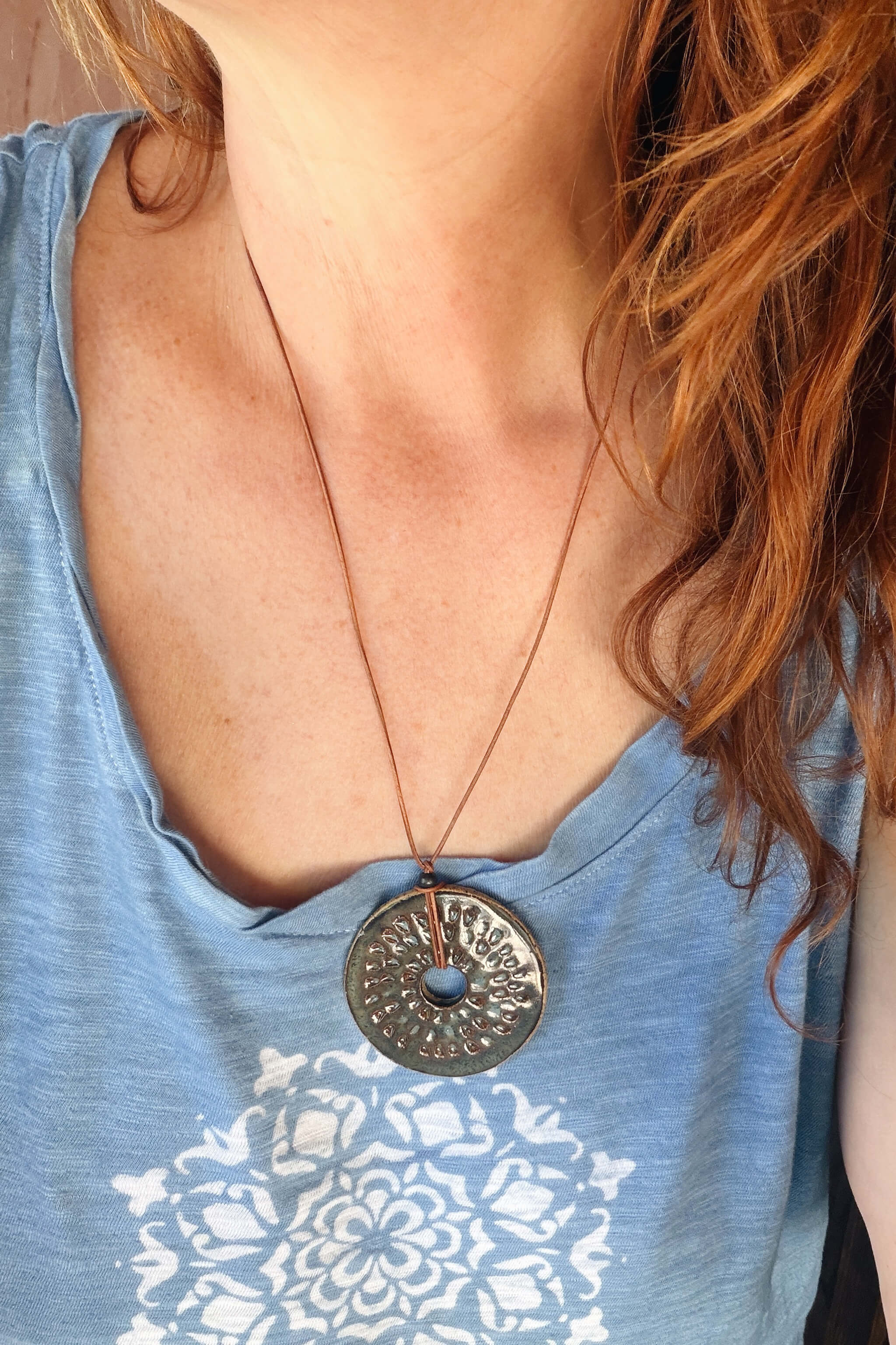 Handmade coastal ceramic sunburst pendant necklace worn at long boho length on caramel Italian leather — From the Fire FTF_0726 by Jester Swink