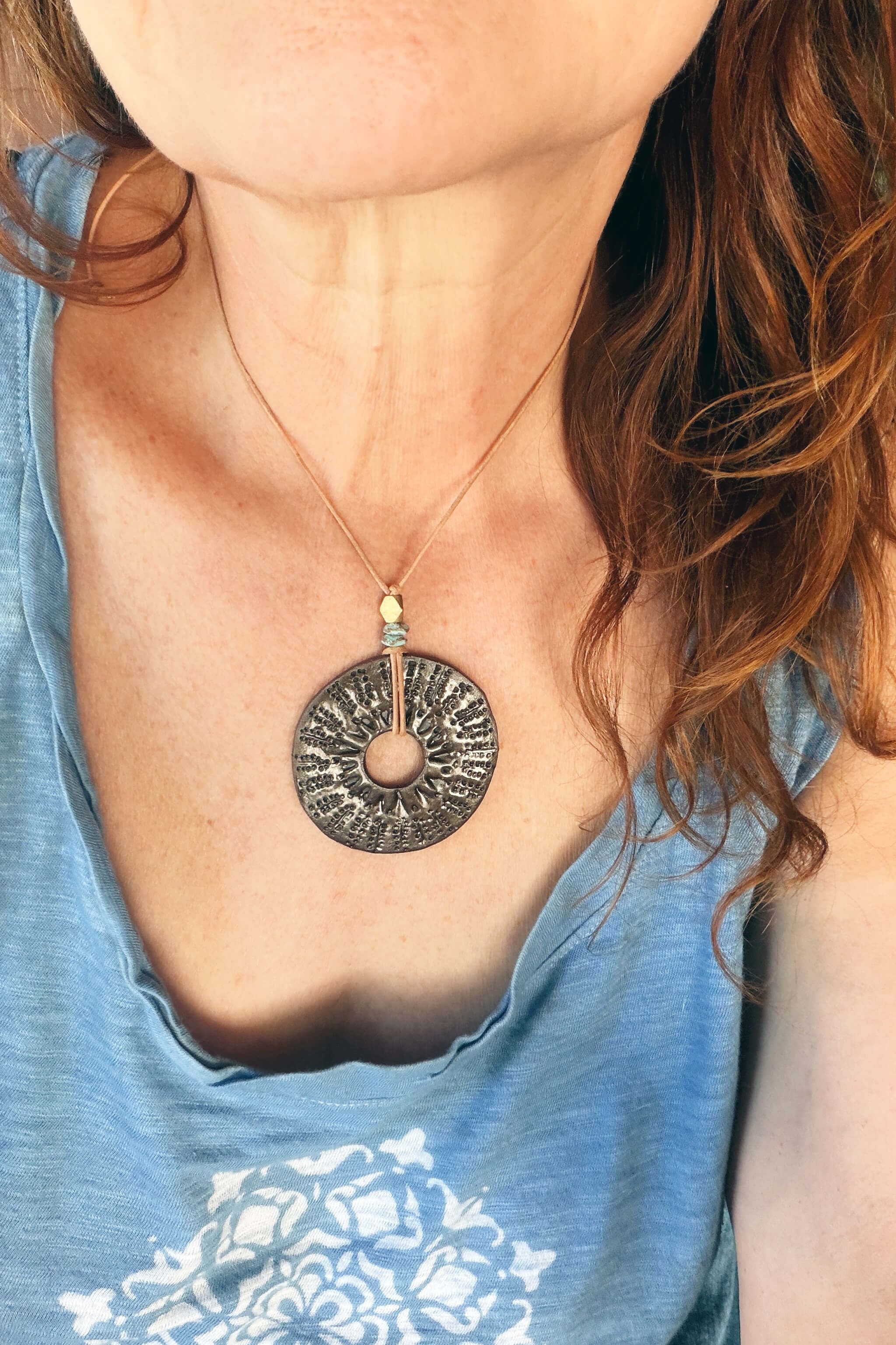 Handmade ceramic sunburst talisman pendant necklace worn at shorter length — boho ceramic jewelry From the Fire FTF_0726 by Jester Swink