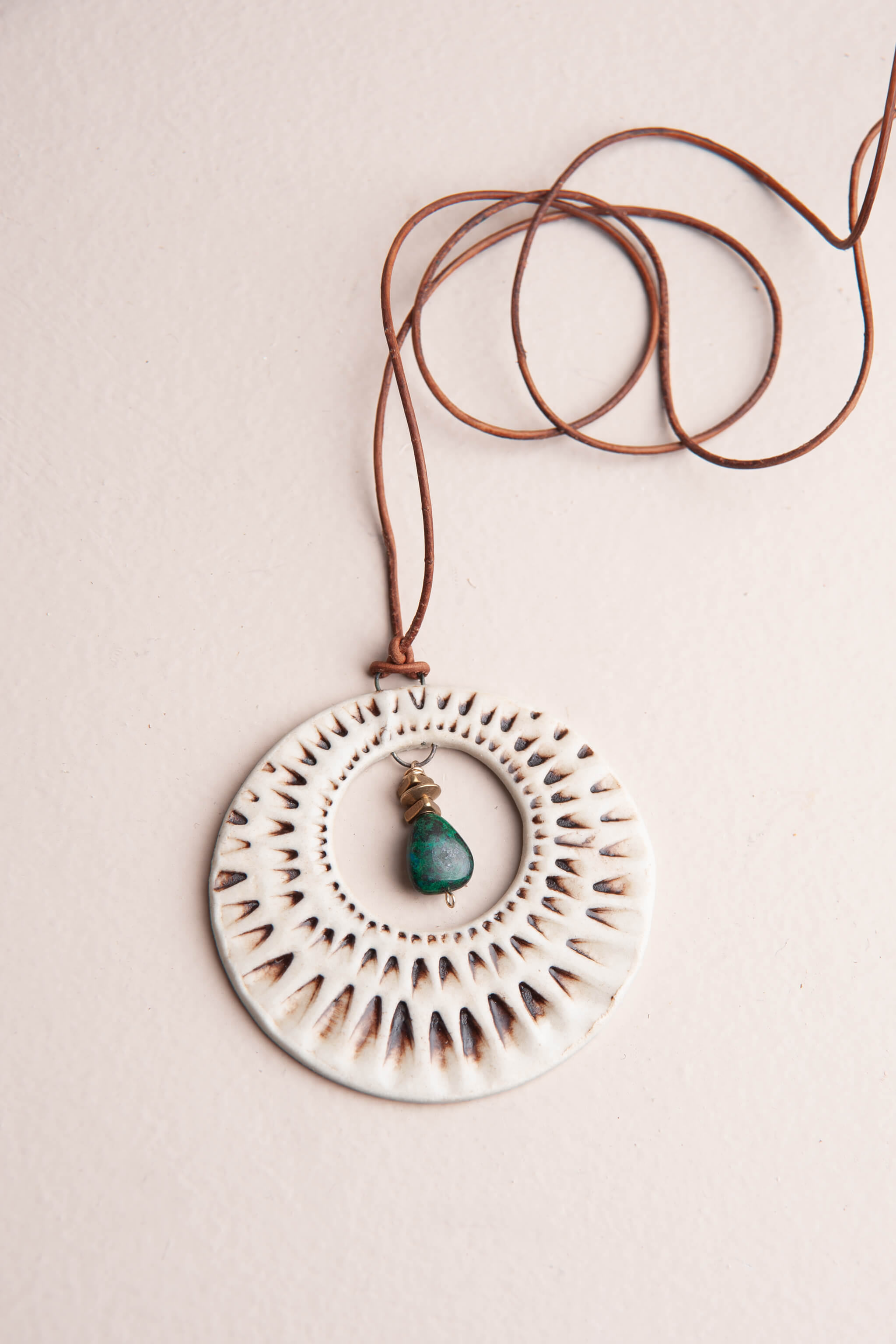 Handmade ceramic sunburst pendant necklace in ivory porcelain with chrysocolla drop on adjustable Italian leather, kiln fired by Jester Swink Santa Cruz Mountains — From the Fire FTF_0726
