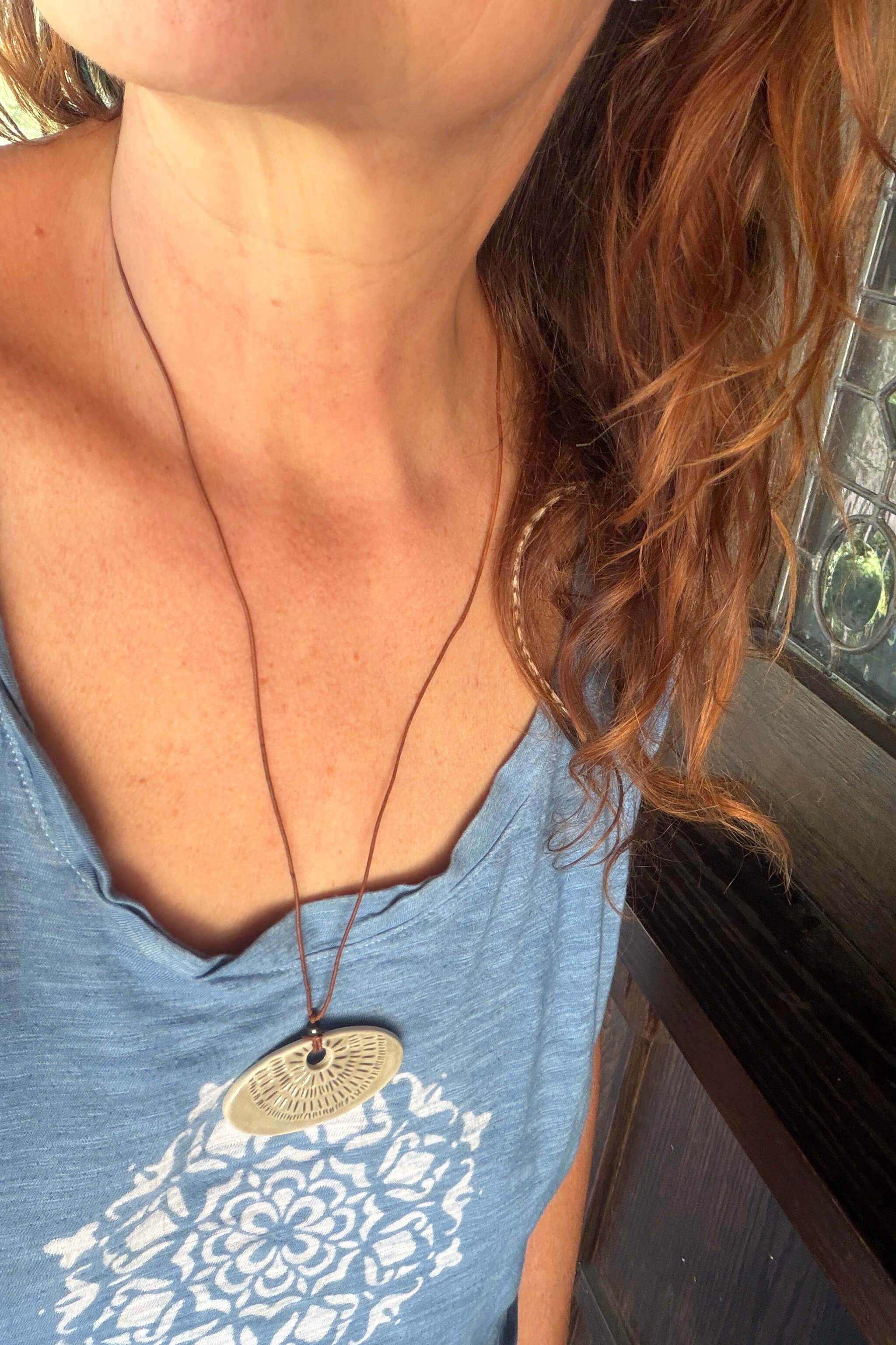 Handmade grey porcelain sunray ceramic pendant necklace worn long on brown leather — minimalist modern ceramic jewelry From the Fire FTF_0726 by Jester Swink